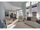 Bright living room with vaulted ceiling, large windows, and comfortable seating, open to the kitchen at 3341 Suffolk Ct, Greenwood, IN 46143
