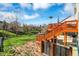 A backyard patio features lush greenery and an easy transition from upper deck to lawn at 3341 Suffolk Ct, Greenwood, IN 46143