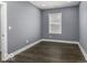 Cozy bedroom features laminate wood floors, large window, and modern trim at 337 E Minnesota St, Indianapolis, IN 46225