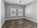 Spacious bedroom with hardwood floors, two windows, and a ceiling fan at 337 E Minnesota St, Indianapolis, IN 46225