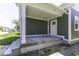 Covered porch features sleek white trim, new siding, and updated front door at 337 E Minnesota St, Indianapolis, IN 46225