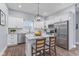 Bright kitchen features stainless appliances, white cabinets, granite counters, and an island with seating at 337 E Minnesota St, Indianapolis, IN 46225