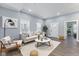 Cozy living room with modern decor, light gray walls, a white couch, and hardwood floors at 337 E Minnesota St, Indianapolis, IN 46225