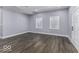 Bright living room with laminate wood floors, large windows, and modern trim at 337 E Minnesota St, Indianapolis, IN 46225