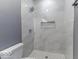 Bright, white shower with patterned floor, shower niche, and modern fixtures at 337 E Minnesota St, Indianapolis, IN 46225