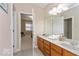 Bathroom with double sink vanity and tile floor, and access to the bedroom at 350 N Meridian St # 205, Indianapolis, IN 46204