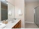 Bathroom with a glass shower, a sink with a vanity, and neutral walls at 350 N Meridian St # 205, Indianapolis, IN 46204