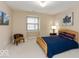 Bright bedroom features neutral walls, a cozy chair, and comfortable-looking bed at 350 N Meridian St # 205, Indianapolis, IN 46204