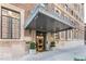 Attractive entrance with a decorative awning, potted plants and a well maintained brick facade at 350 N Meridian St # 205, Indianapolis, IN 46204