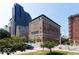 Beautiful exterior shot of a brick building in a cityscape with mature trees and manicured lawn at 350 N Meridian St # 205, Indianapolis, IN 46204