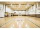 Spacious gymnasium with hardwood floors, basketball hoops, and ample natural light at 350 N Meridian St # 205, Indianapolis, IN 46204