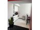 A small kitchenette with white cabinets, black countertop and decorative plants adds convenience to the space at 350 N Meridian St # 205, Indianapolis, IN 46204
