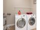 Laundry room with washer, dryer, shelving, and tiling on the floor at 350 N Meridian St # 205, Indianapolis, IN 46204