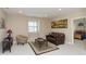 Comfortable living room with a leather sofa, area rug, natural light and view to an adjacent bedroom at 350 N Meridian St # 205, Indianapolis, IN 46204