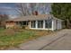 Single story home featuring a driveway with basketball hoop and attached garage at 3510 Chamberlin Dr, Indianapolis, IN 46237