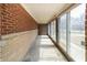 Enclosed sunroom with brick accent wall and lots of light at 3510 Chamberlin Dr, Indianapolis, IN 46237