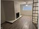 Basement with a fireplace, ladder and window at 3519 N Whitcomb Ave, Indianapolis, IN 46224