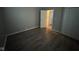 Bedroom with wood-look flooring, neutral paint and closet at 3519 N Whitcomb Ave, Indianapolis, IN 46224