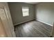 Bedroom with hardwood flooring and a window at 3519 N Whitcomb Ave, Indianapolis, IN 46224