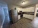 The kitchen features stainless steel refrigerator and modern appliances at 3519 N Whitcomb Ave, Indianapolis, IN 46224