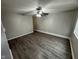 Bright living room featuring dark vinyl floors, a ceiling fan, and neutral walls at 3519 N Whitcomb Ave, Indianapolis, IN 46224