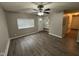 Open living room with vinyl floors, built-in shelving, and a ceiling fan at 3519 N Whitcomb Ave, Indianapolis, IN 46224