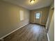 Room featuring neutral paint and wood-look flooring at 3519 N Whitcomb Ave, Indianapolis, IN 46224