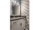 This half bath features a decorative mirror and heron-themed wallpaper at 3849 Sun Valley Dr, Westfield, IN 46074