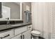 The modern bathroom showcases a sleek vanity and a shower with geometric patterned walls at 3849 Sun Valley Dr, Westfield, IN 46074