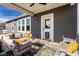 This covered porch has outdoor seating, a rug, and a pet door at 3849 Sun Valley Dr, Westfield, IN 46074