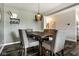 Dining room with a wooden table, upholstered chairs, and modern light fixture at 3849 Sun Valley Dr, Westfield, IN 46074