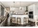 Open concept kitchen with white cabinetry, stainless steel appliances, and a breakfast bar with seating at 3849 Sun Valley Dr, Westfield, IN 46074
