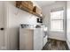 This laundry room features a front-loading washer and dryer with wooden style vinyl floors at 3849 Sun Valley Dr, Westfield, IN 46074