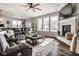 Bright living room featuring a stone fireplace, large windows, and a comfortable sectional sofa at 3849 Sun Valley Dr, Westfield, IN 46074