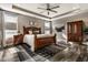 Bedroom with tray ceilings, a wooden bed frame, and decorative rug at 3849 Sun Valley Dr, Westfield, IN 46074