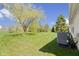 Well maintained backyard with mature tree and air conditioning unit at 3856 Cornwallis Ln, Carmel, IN 46032