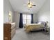Bright bedroom featuring a bed, dresser, and ample natural light from the window at 3856 Cornwallis Ln, Carmel, IN 46032