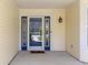 Welcoming front entryway with a glass storm door and exterior light fixture at 3856 Cornwallis Ln, Carmel, IN 46032