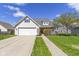 Charming home with a two-car garage, landscaped front yard, and inviting front porch at 3856 Cornwallis Ln, Carmel, IN 46032