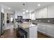 Bright kitchen featuring white cabinets, a gray backsplash, a kitchen island, and stainless appliances at 3856 Cornwallis Ln, Carmel, IN 46032