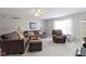 Inviting living room with comfortable seating, bright window, and a ceiling fan at 3856 Cornwallis Ln, Carmel, IN 46032