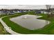 Community pond with a fountain, surrounded by lush green lawns and a walking path, enhances this community at 4016 Railhead Ave, Westfield, IN 46074