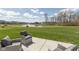 Relax on the patio and enjoy the serene view of the neighborhood pond with its fountain and lush green surroundings at 4016 Railhead Ave, Westfield, IN 46074