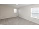 Bright bedroom boasts neutral paint, soft carpeting, and two large windows that brighten the room with natural light at 4016 Railhead Ave, Westfield, IN 46074