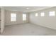 This carpeted bedroom offers abundant natural light through three large windows, complemented by neutral walls at 4016 Railhead Ave, Westfield, IN 46074