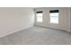 Well-lit bedroom with plush carpeting, large windows, and neutral walls, offering a cozy and inviting space at 4016 Railhead Ave, Westfield, IN 46074