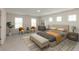 Spacious primary bedroom with ample windows, neutral color scheme, and comfortable seating area at 4016 Railhead Ave, Westfield, IN 46074