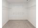 This walk-in closet features built-in shelving and neutral carpeting at 4016 Railhead Ave, Westfield, IN 46074