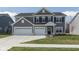 Beautiful two-story home with a well-manicured lawn, three-car garage and gray siding for great curb appeal at 4016 Railhead Ave, Westfield, IN 46074