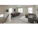 Finished game room with billiards table, comfortable seating, and plenty of natural light at 4016 Railhead Ave, Westfield, IN 46074